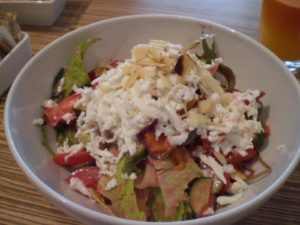 A gigantic, fresh salad topped with sheep's milk cheese and almonds