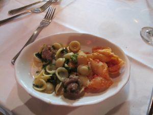 Orecchiette with sausage and broccoli rabe alongside shells with fresh ricotta