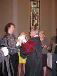 Pastor Jim Hughs performing the baptism sacrament