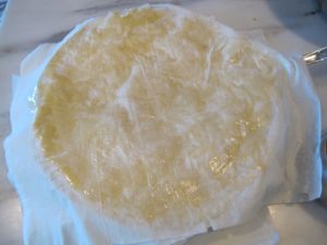 Once filled, the bisteeya was enclosed using more layers of buttered phyllo.  It was then baked to a golden brown and dusted with confectioner's sugar and cinnamon.