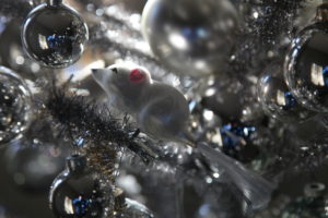 The silver tree is adorned with these funny mouse ornaments.