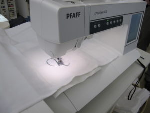 A Pfaff embroidery machine from Above and Beyond Creative Sewing monograms dishtowels.