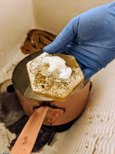 Whenever cleaning any precious metal, always use a soft moistened sponge. A soft cloth can also work well. Here, Carlos puts a good amount of cream onto the sponge.