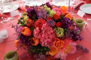 The lovely and colorful flower arrangements were created by Robert Downs Clark Floral Design and the coral-colored linen is from Party Rental Ltd.