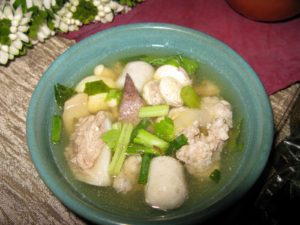 Thai soup with fish, scallion, taro, and greens