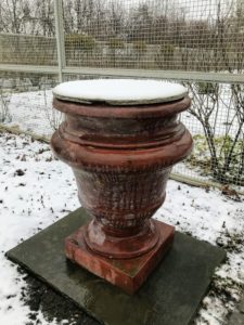 This urn is one of a pair of stately Kenneth Lynch garden urns flanking the entrance to the flower cutting garden. They are more than 500-pounds each. The pair, which is wrapped in burlap during winter, was just uncovered - only the plywood on top remains.