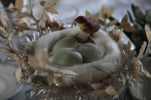 Spun cotton nests, embellished with tinsel and tiny birds, sat on the table and were filled with blown out real eggs.