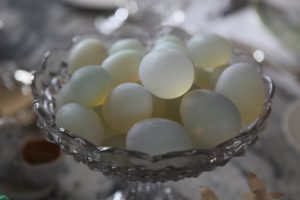 Alabaster eggs were arranged in glass compotes.