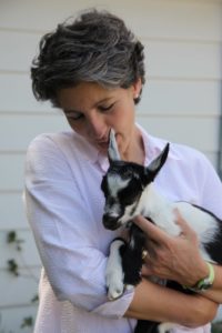 This is Lisa Schwartz holding one of her newborn kid goats.