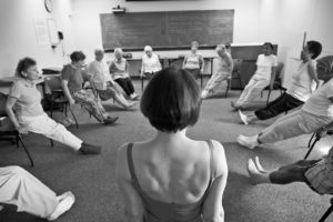 Deborah Quilter leads a chair yoga class