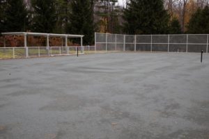 The tennis court with net down and lines lifted