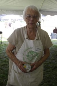 Ruth Robertson - 93-years-old and the oldest member of the Herb Society of America - holding a jar of her famous tarragon mustard.