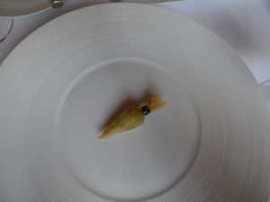 A small carrot shaped fried cornucopia filled with sweetbreads.
