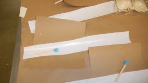 This is the freezer paper and small sponges that are used to dab glue on the item being decorated. The glue should cover the surface area inside the stencil.