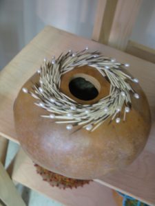 This gourd is embellished with porcupine quills and pearls.
