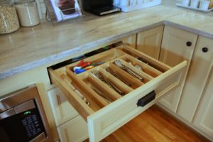 The utensil drawer is separated with wooden dividers.