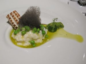 Risotto with peas, calamari, and black squid foam