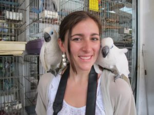 Sophie posing with two lovely cockatoos