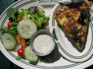 A delicious vegetable quiche served with a fresh garden salad and cucumber-yogurt dressing flavored with fresh dill