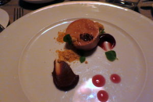 Pate de foie gras served with peanuts, chocolate, and pomegranate