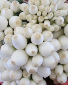 Mounds of white onions in all sizes