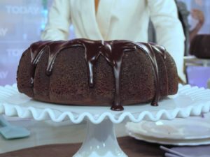 Sleek mahogany ganache over a rich chocolate cake
