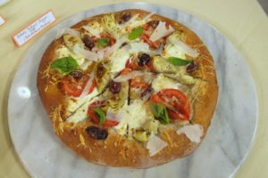 Another delicious recipe from Power Foods -- whole-wheat pizza with artichoke hearts and pecorino, plus sliced tomatoes Kalamata olives, and ricotta cheese.