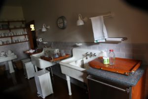 The wash-up area is across from the stoves.  The two enameled sinks are original to the house.