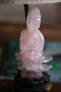 The base of the little lamp that sits atop the desk is a Chinese figure made from pink jade.