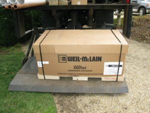 Unloading one of the two high efficiency Weil-McLain Ultra Condensing Gas Boilers