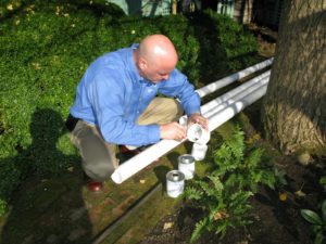John Resso from Weil McLain was busy gluing the sections of PVC venting pipes together, making them long enough to extend down the chimney to the basement.