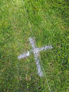 An "x" marks the spot where each tree will be centered and planted. Chhiring uses marking spray, often used for landscaping jobs. Knowing the mature size and spread of a tree is crucial in determining exactly where trees should be placed.