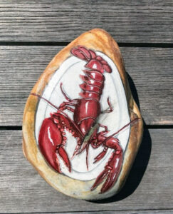 Here is a painted rock - also decorated with a lobster on a plate.