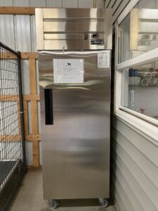 Here is my reach-in freezer that stores my dogs’ frozen foods. It is from Dukers USA. It is particularly important to keep these foods frozen until used to protect against bacterial growth and spoilage. I chose the safest freezer I could find - one that won't overheat and cause a fire. I also keep a feeding schedule and a measurement chart on the freezer so everyone knows what dog gets what and when they get it.