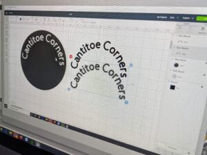 Because the labels will be circular in shape, we needed to curve any writing. At the top toolbar, Shqipe then clicks "curve" to control how much curve the text needed in order to fit properly. Next, Shqipe layered the words on top of the circle and clicked "slice."