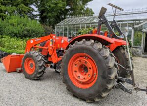 We keep our big Kubota tractor parked in the Equipment Barn also. Here it is outside already in use for the day. This is my model M7060HD12 tractor.