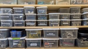 In a storage closet, we keep a lot of the smaller supplies and tools – all organized in labeled clear plastic bins.