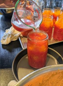 Once the air bubbles are removed, you'll be surprised at how much more room there is to add more tomato juice. Leave a 1/2-inch of space at the top of each jar’s neck, so there is room for expansion when it is heated.