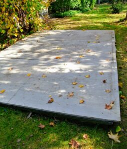 Here is one pit already covered with plastic and plywood. To make the plywood look less unsightly, we then cover the entire surface with burlap.