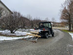 Here is Fernando "dragging the carriage roads" last December before my holiday party. This means, raking the gravel along the roads to level and tidy them. The soft rakes are attached to pieces of wood and hooked up to the back of our Polaris ATV. An additional piece of wood is placed on top for added weight. The crew gets all four miles of carriage road raked pretty quickly using our own handmade and "right tool for the right job."