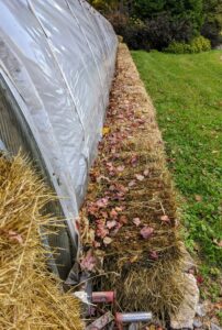 It also has manual roll-up curtains on both sides for ventilation purposes. We added some bales of hay, which were made here at the farm, to help insulate the space even more.