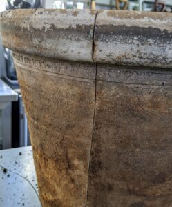 This slightly larger pot cracked. For this one, Ryan starts by examining the crack and determining where it starts and ends. A large crack is easy to find, but for less noticeable ones, spray some water on the crack and then wipe the water away - the crack will be more visible.