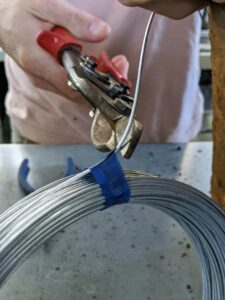 Use a malleable gauge wire. Wire is available at any hardware store. Copper wire also works well. Ryan cuts a piece that is about six-inches longer than the circumference of the pot's top.