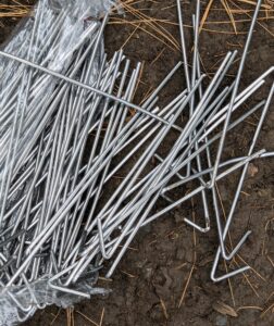 They secure it with these chain link fence wire ties, also known as chain link hook ties, or chain link fence tie wires. They are constructed from a heavy duty bendable gauge wire.