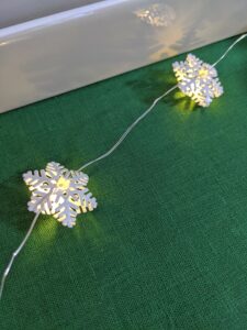 This is my six-foot Snowflake Microlight Strand. It looks excellent set around the table draped on a plant in your home – they are so lightweight.