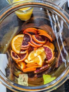Use sturdy, flavorful fruits that can sit in a jar or pitcher for a long time without disintegrating. This time of year, citrus, apples, pears, and pomegranates all make great sangria options. in These fruits were macerated overnight and then placed in this wide-mouth glass container.