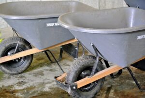 Near the ladders, we keep all the wheelbarrows. These are very helpful for carrying mulch and tools to various gardens. I always remind the crew to use the right tools for the right jobs and to bring everything they may need to complete specific tasks.
