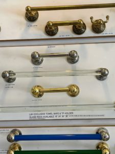 These are antique brass, nickel, and glass towel bars, hooks, and toilet paper holders, circa 1900.