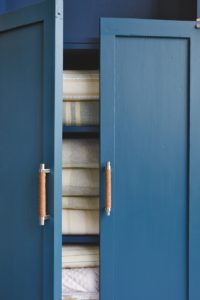 Make your armoire one-of-a-kind with custom cabinet pulls made with the same leather tape often used to repair leather goods. Just wrap around the handles and add a few stitches to secure the ends.