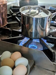 The water is just about boiling. A covered pot boils faster than an uncovered one because the cooling presence of the room's atmosphere is greatly diminished. And notice, the lid is askew on top of the pot - just so it doesn't boil-over.